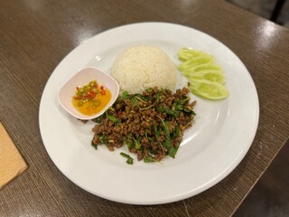 Stir-fried minced pork with basil leaves on rice. Delicious taste. 