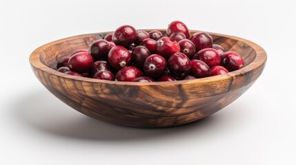 A wooden bowl filled with fresh, ripe cranberries on a white background. Perfect for holiday meals and healthy snacking.
