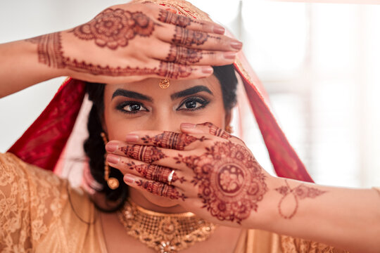 Indian bride, portrait and henna for marriage, celebration and love for wedding. Woman, accessories or culture for traditional mehendi hands, sari or hindu bridal jewelry for commitment and happiness