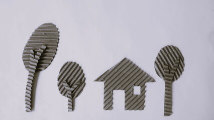 House and tree  made of cardboard on a white background. Children creativity art project. DIY concept. Cardboard craft. Copy space