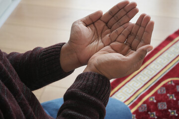 muslim man keep hand in praying gestures during ramadan, Close up 