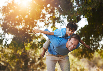 Portrait, father and piggyback child at park for laugh, care or family bonding together in nature....