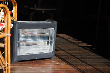 Modern electric infrared heater in living room, closeup