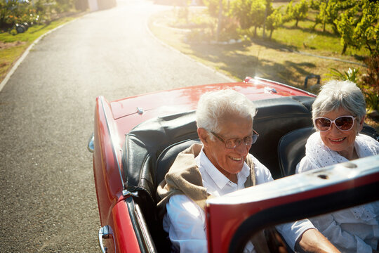 Senior, couple and driving convertible car for holiday road trip or countryside retirement, transportation or summer. Man, woman and old people on travel journey in Napa country, exploring or happy