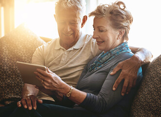 Happy, senior couple and relax with tablet for browsing, research or reading news on sofa at home....