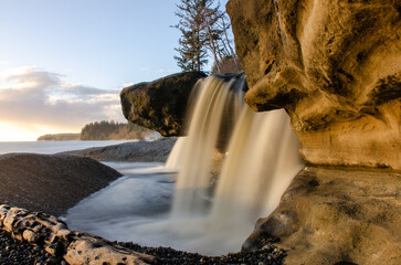 A waterfall onto a beach on the Pacific coast of Vancouver Island Canada
