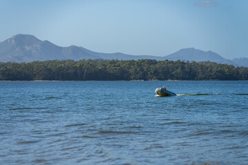 tinny dinghy boat on a river in a national park in the australian bush, On the beach