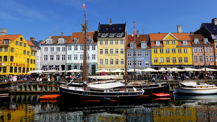 COPENHAGEN, DENMARK, APRIL 27, 2024: Copenhagen iconic view. The popular Nyhavn port area with the colorful houses in the center of Copenhagen, Denmark during spring season sunny day
