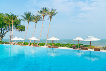 umbrella with bed pool around swimming pool with ocean sea background