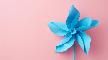 Close up view of a blue pinwheel shot on pink background the composition