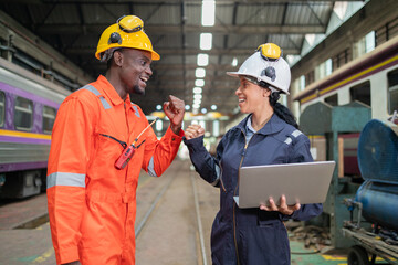 Railway Engineers Collaborating with Laptop on Site