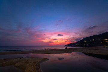 sweet sky at sunset reflection in the beach puddle. The sun's rays glistened in the puddle creating a mesmerizing dance of colors. stunning colorful reflection in sea surface.colorful sky