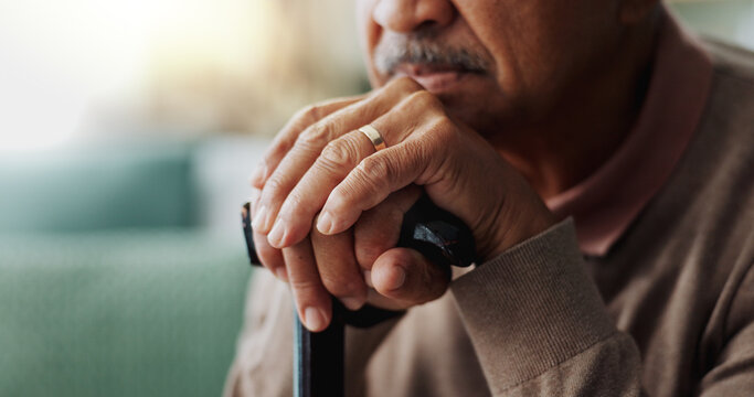 Old man, hands and walking stick in home for retirement grief for remember nostalgia, memory or thoughts. Male person, cane and wedding ring for elderly widower or unhappy, contemplating or lonely