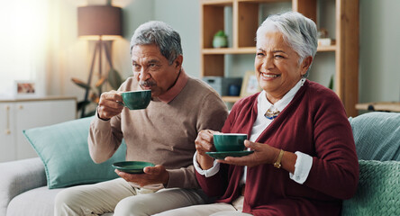 Senior couple, happy and coffee on sofa in house, home and living room for retirement. People, elderly partners and family drinking tea, laughing and relax on couch for love, bonding and affection - Powered by Adobe