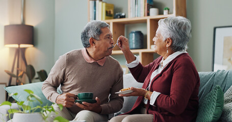 Home, cake and elderly couple with coffee for love, bonding and funny conversation on sofa. Senior...