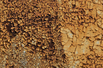 Close-up of a decaying metal surface with peeling paint. The rust and weathered texture create a...
