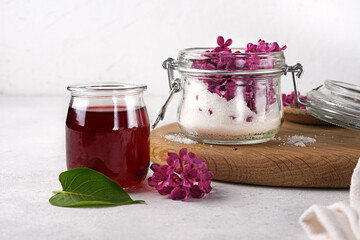 Preparation of syrup from the flowers of lilac. Glassware. White slate background. Copy space