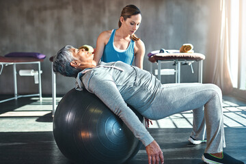 Workout, physiotherapist and senior woman with ball in clinic for physiotherapy, support or...
