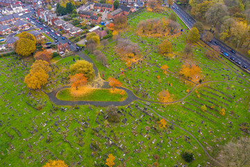 Aerial photo overlooking a grave yard cemetery in the autumn time, taken in the village of Beeston in Leeds West Yorkshire UK