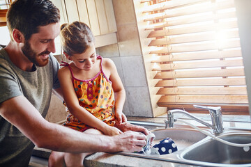 Washing dishes, father and child in home kitchen for family hygiene, housework and learning. Dad,...
