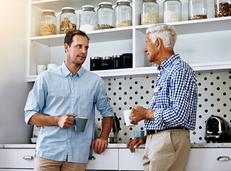 Man, advice and senior father in kitchen with conversation in morning with coffee for help or...