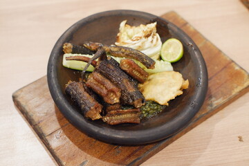 Javanese cuisine, grilled eel and pickled cucumber on plate