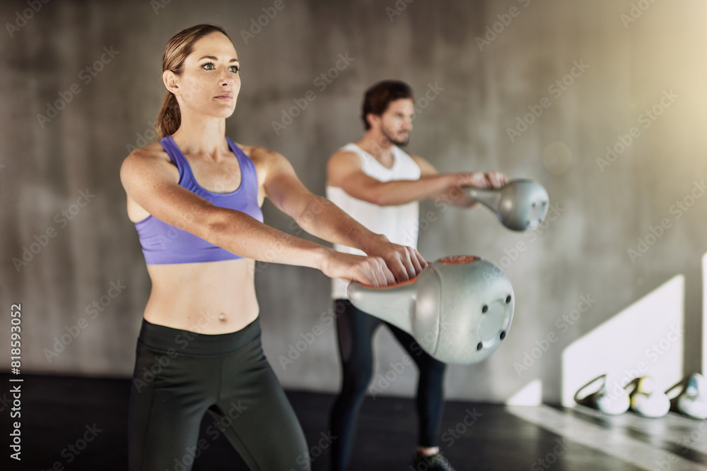 Sticker Training, man and woman in gym with kettlebell, fitness and power at workout challenge together. Couple, sports club and personal trainer with weights, muscle development and healthy body exercise