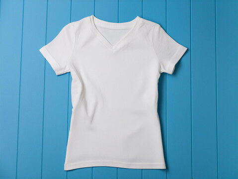Plain white v-neck T-shirt mockup with space for deign or logo, on blue background.