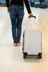 Hand people holding luggage. Business woman plan and backpack see the airplane at the airport.Young woman ready to go on vacations