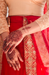 Indian bride, hands and henna for wedding, celebration and love for marriage. Woman, mehndi and culture with traditional temporary tattoo, sari and hindu bridal jewelry with accessory and red veil