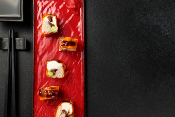 Japanese food: sushi, Mami roll with snow crab. Black background