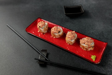 Japanese food: sushi, Shiitaki roll with tuna, avocado, Philadelphia, kimchi, tuna flakes Black background