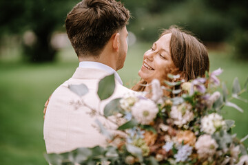 Fototapeta premium Riga, Latvia, - August 26, 2024 - Close-up of bride and groom embracing, looking at each other intimately.