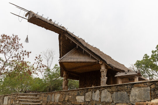 artistic rural tribe traditional home made of bamboo twigs and mud at village at day