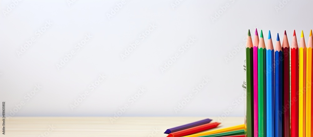 Aufkleber on a table a spiral notebook with a white background is accompanied by colored pencils creating a vi