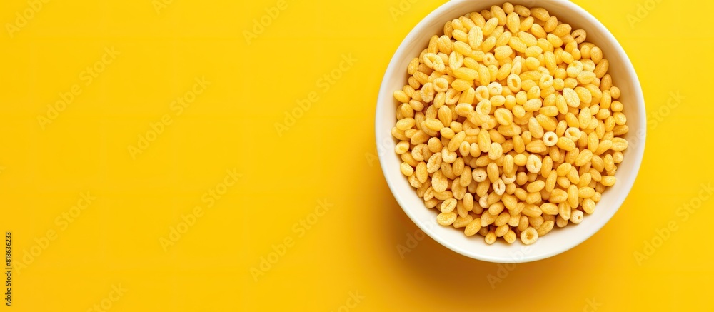 Aufkleber top view of honey air rice puffed wheat cereal on a yellow background with copy space image