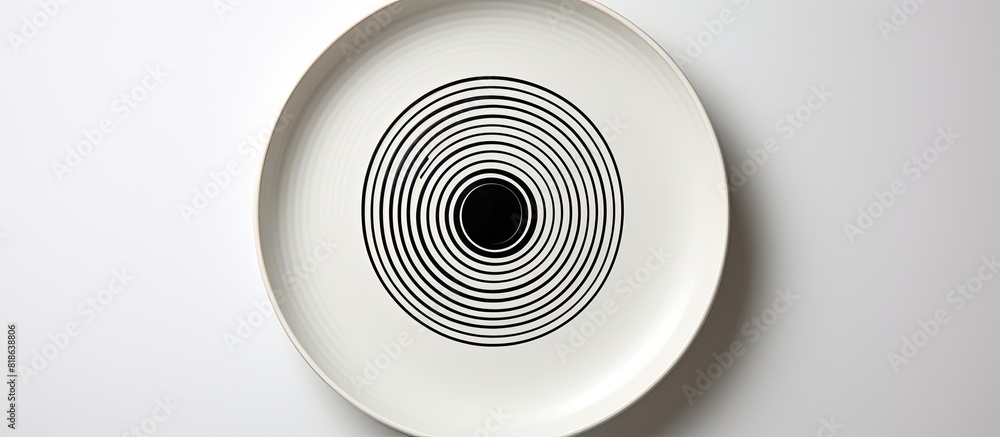 Aufkleber the ceramic plate has a black circle in the center and is placed on a white background the image can