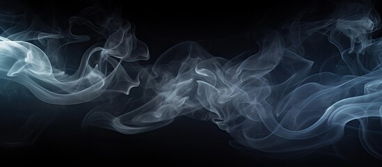 An abstract dark background with white smoke creating a copy space image