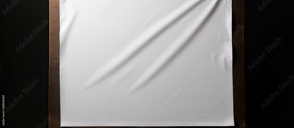 Poster a white sheet with copy space image held vertically against a dark background
