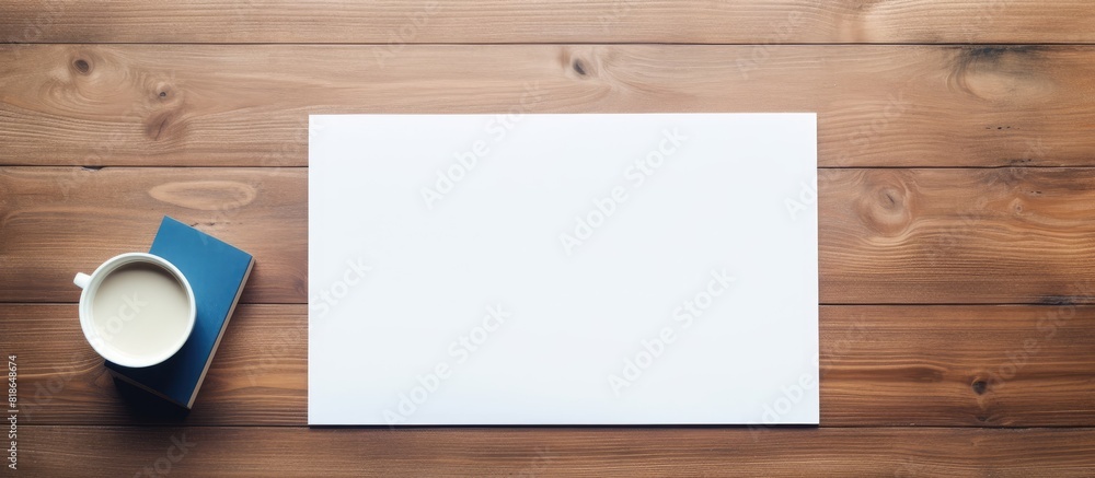 Fototapete From a top view perspective there is a wooden table with a clipboard featuring blank paper and a blue pen on it The desk offers ample copy space for adding text or images