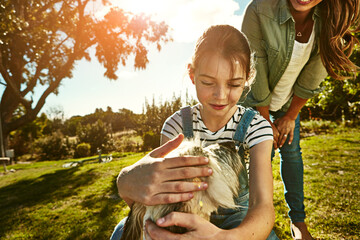 Outdoor, mother and girl with dog, fun and sunshine with weekend break, happiness and nature....