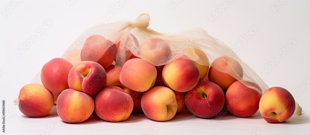 Poster Nectarines arranged in a white string bag against a white background with sufficient space for additional content