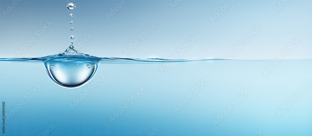Aufkleber A drop of water caught in mid air suspended in the frame with a blank space around it creating the perfect copy space image