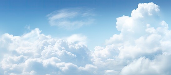 Abstract background featuring a blue sky and clouds with ample space for additional content or text