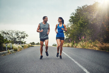 Couple, road and smile with running for fitness for training, support and love in California....