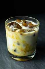 Cocktail with frozen coffee and milk in glass on grey background 