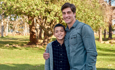 Fototapeta premium Kid, boy and hug father in park with love, support and happy for reunion or play outdoor. Family, dad and child bonding together in portrait for security, care and childhood with growth in nature