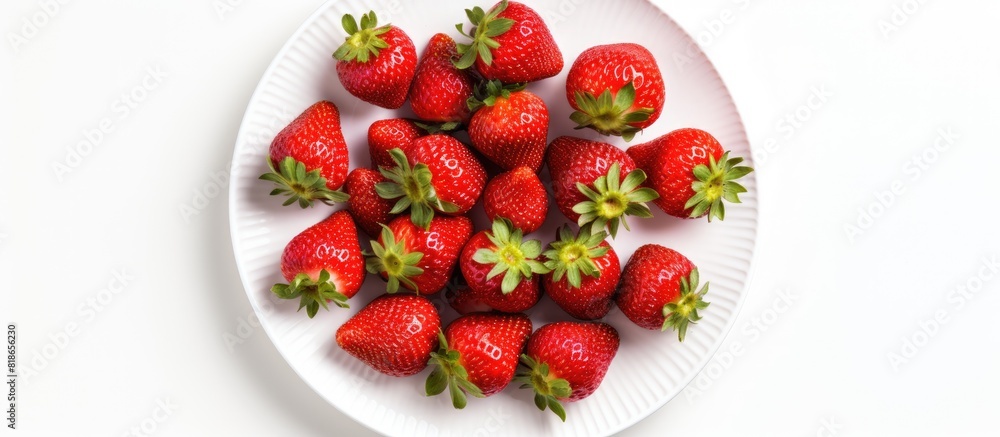 Aufkleber A close up view from above of a plate of fresh strawberries which are part of a healthy raw diet The image is isolated on a white background and includes copy space for text or framing