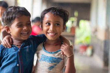 Rural indian Children laughing at smiling whilst Standing at school