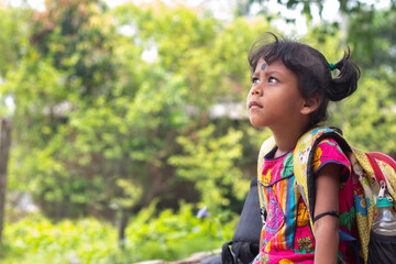 Rural School Children with backpack, sitting outside and looking up